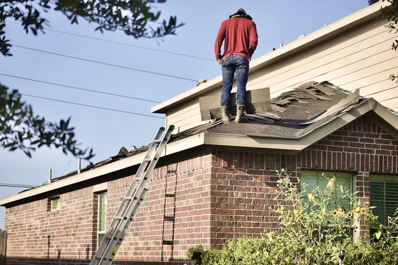 Professional roofer working on a residential roof in Madison Valley